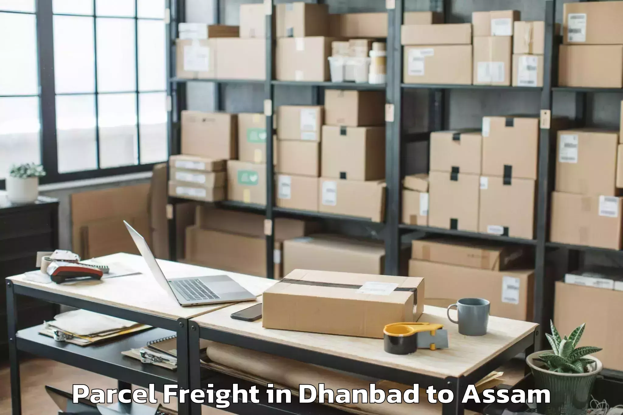 Top Dhanbad to Jamuguri Parcel Freight Available